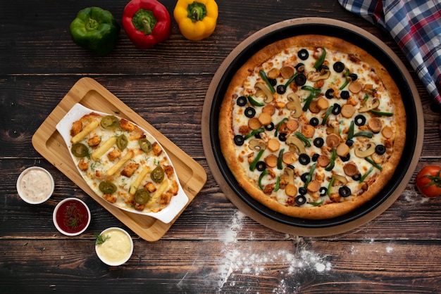 Pizza with  Cheese fries on wooden table, top view