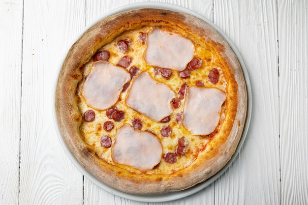 A pizza with cheese and ham on it