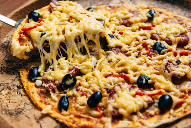 Pizza with cheese olives and salami