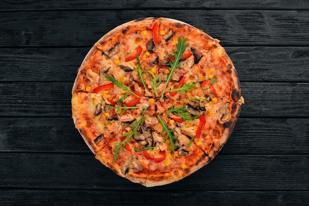 Pizza with chicken and mushrooms Top view On a wooden background Copy space