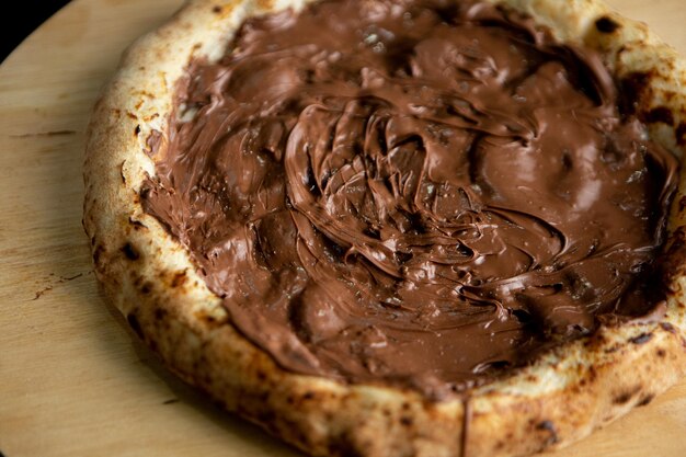 A pizza with chocolate frosting on it