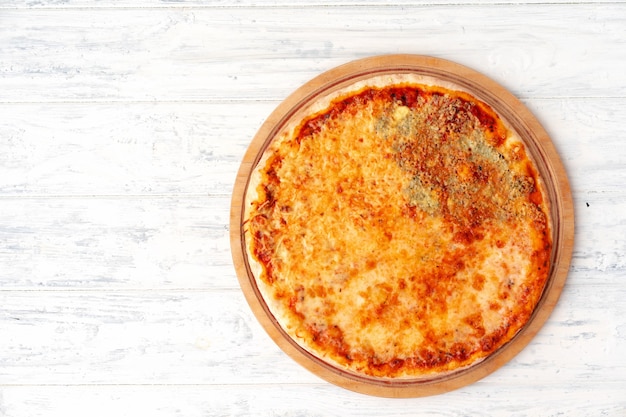 Pizza with four cheeses served on wooden