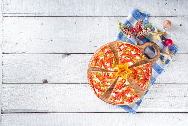 Pizza with ingredient in the form of Christmas decorations