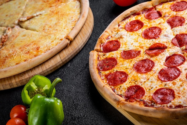 Pizza with ingredients on a dark background