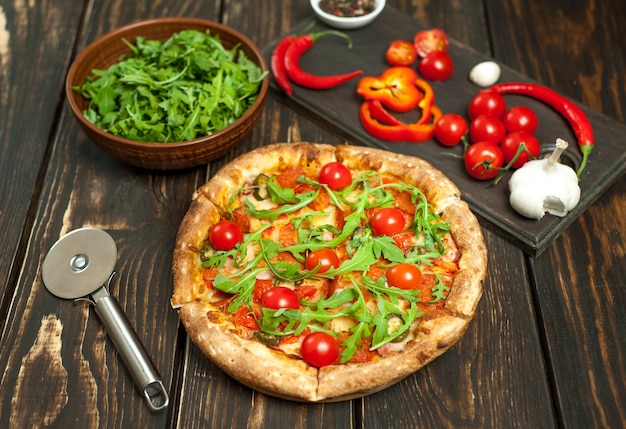 Photo pizza with ingredients on wood background