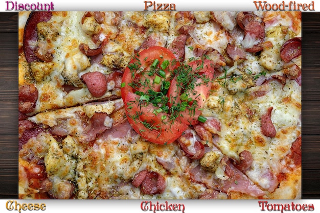 Pizza with meat sausage and chicken cheese and tomatoes on a gray concrete background with selective focus