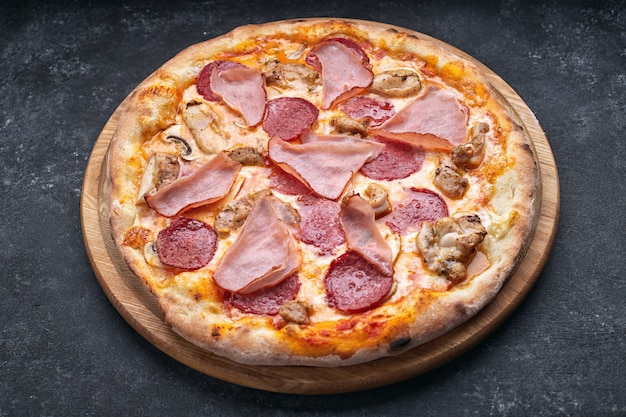 Pizza with meat, sausage, meat and mushrooms on a gray background with place for text. Pizza 4 meat