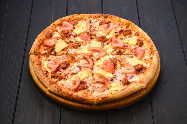 Pizza with minced meat cheddar and tomato