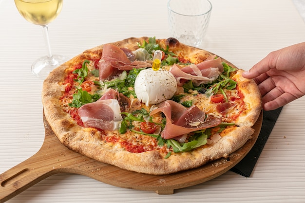 Pizza with mozzarella and raw ham