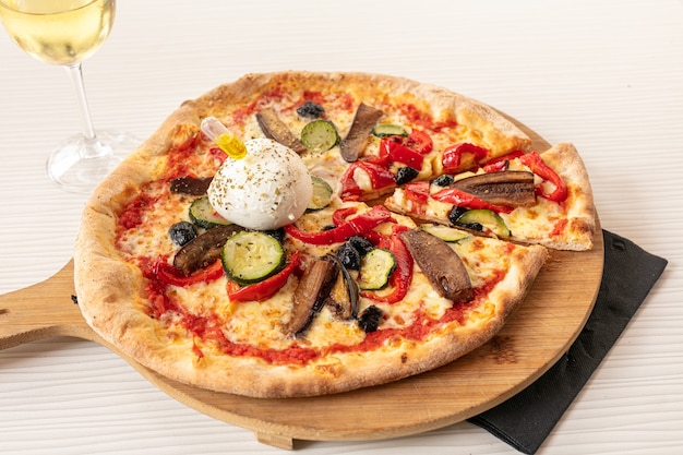 Pizza with mozzarella and vegetable served on a board