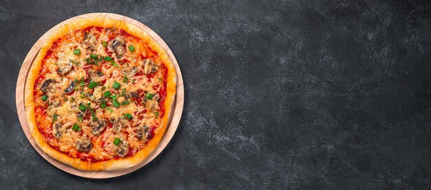 Pizza with mushrooms cheese and tamatomi on a black background