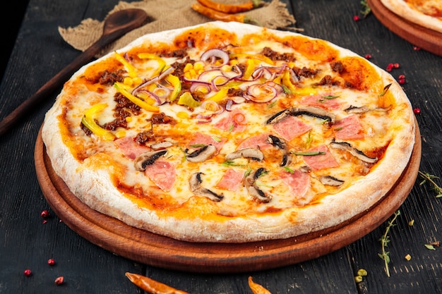 Pizza with mushrooms ham bell pepper and onion