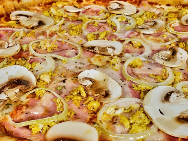 Pizza with mushrooms and ham close up