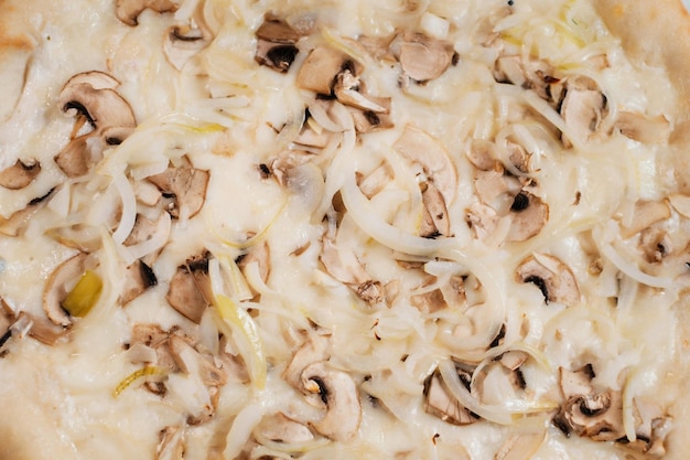 Pizza with onion cheese and mushrooms closeup