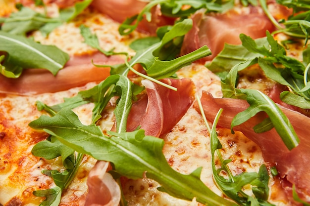 Pizza with Parma ham and arugula, mozzarella cheese