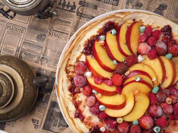 A pizza with peaches and peaches on top of it.