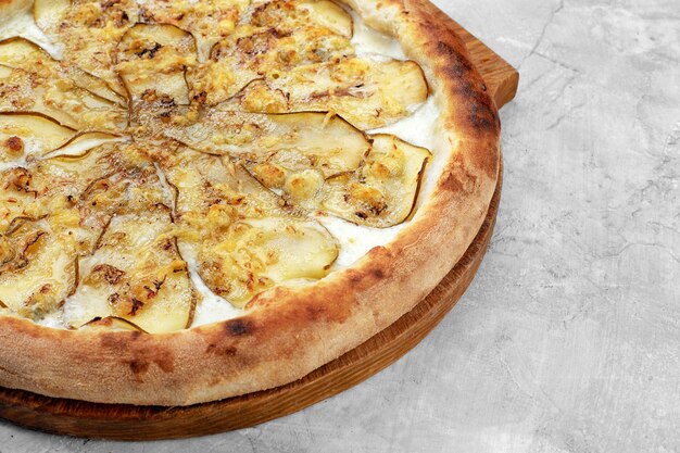 Pizza with pear gorgonzola and on stone background Top view