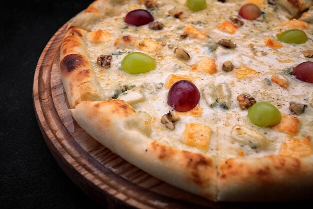 Pizza with pineapples grapes chicken and nuts