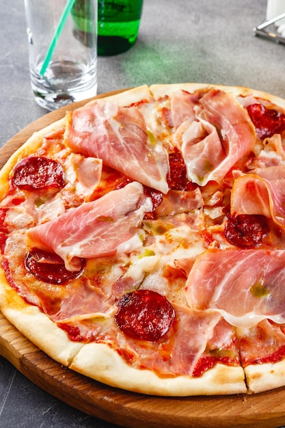 Pizza with salami and prosciutto