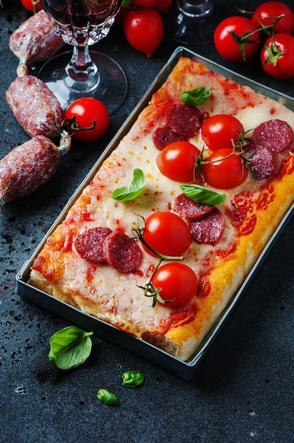 Pizza with salami and tomato