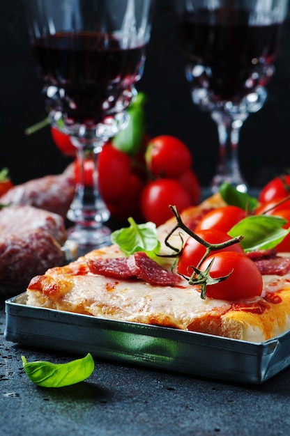 Pizza with salami and tomato