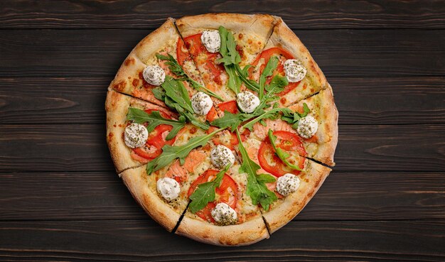 Pizza with salmon tomatoes cheese and spices