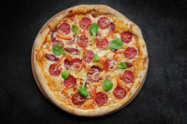 Pizza with sausage and bell pepper closeup studio light