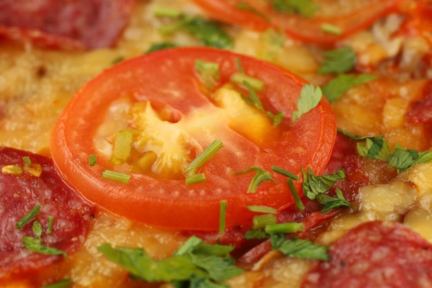 Pizza with sausage tomatoes and cheese closeup Hot tasty traditional italian pizza