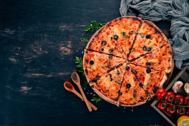 Pizza with seafood and cheese Top view On a wooden background Copy space