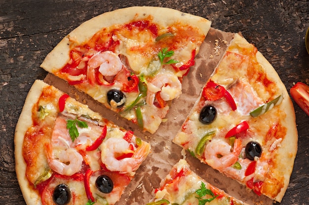 Pizza with shrimp, salmon and olives