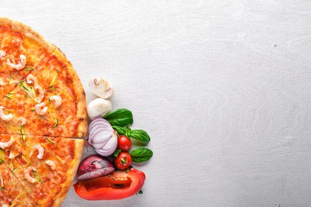 Pizza with shrimp on a wooden background top view free space for text