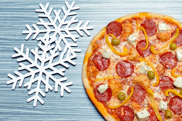 Pizza with snowflakes decoration. Winter pizza