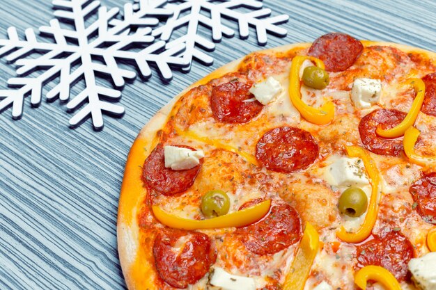 Pizza with snowflakes decoration. Winter pizza