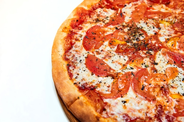 Pizza with tomatoes cheese and spices on a wooden board