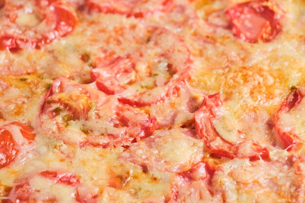 Pizza with tomatoes sausage and cheese closeup