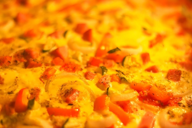 Pizza with vegetables and meat baking in the oven