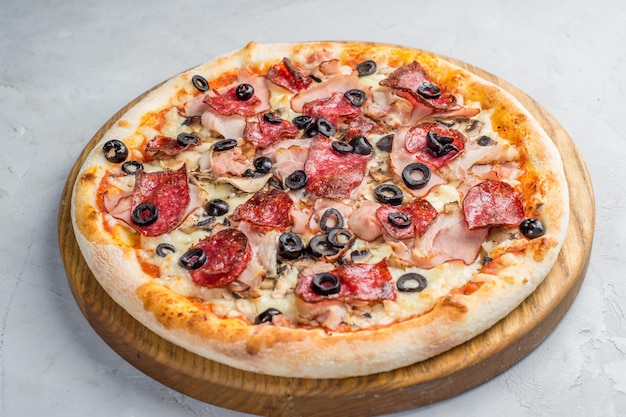 Pizza with vegetables sausages and ham