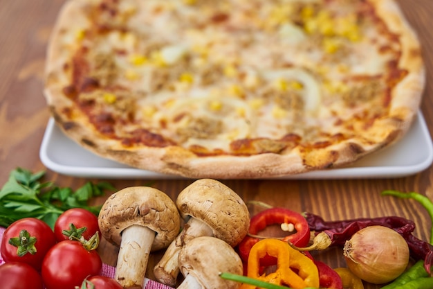 Pizza with Vegetables on Wooden Table