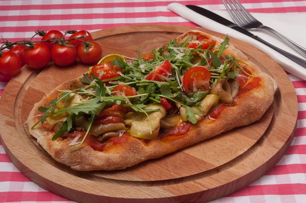 Pizza with zucchini, sweet pepper, onion, mushrooms and parmesan