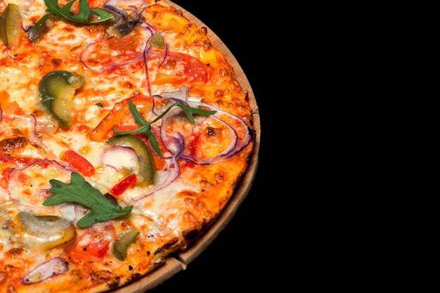 Pizza on a wood board on a black background