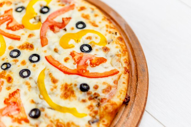 Pizza on wooden plate