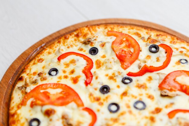 Pizza on wooden plate