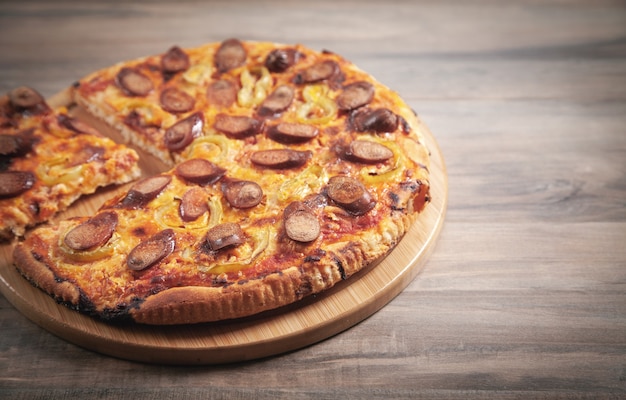 Pizza on wooden table background.