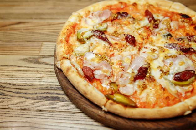 Pizza on wooden table top view