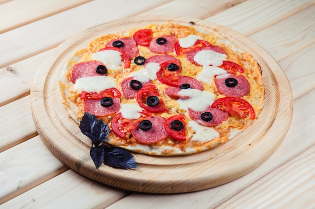 Pizza on the wooden table top view