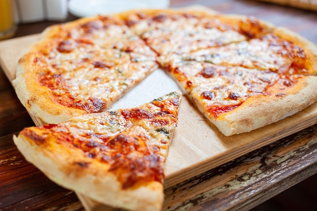 Pizza on a wooden tray cooked in the oven.