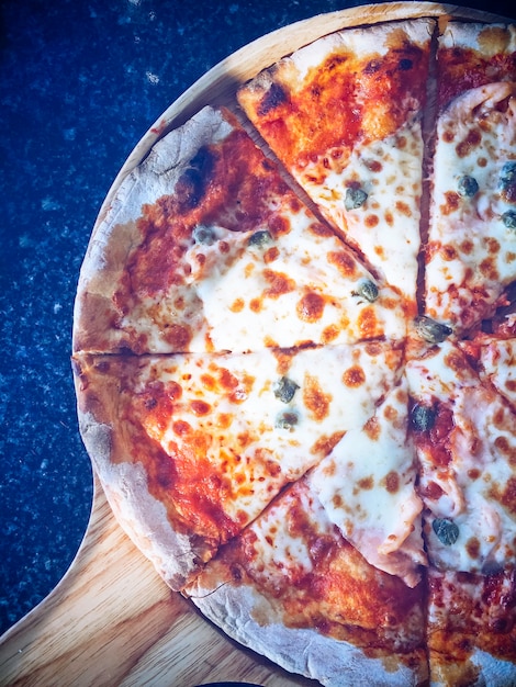 Pizza on wooden tray.