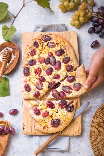 Pizzakorst met geitenkaas en rode druiven. vegetarisch, graanvrij, koolhydraatarm, glutenvrij dieetconcept