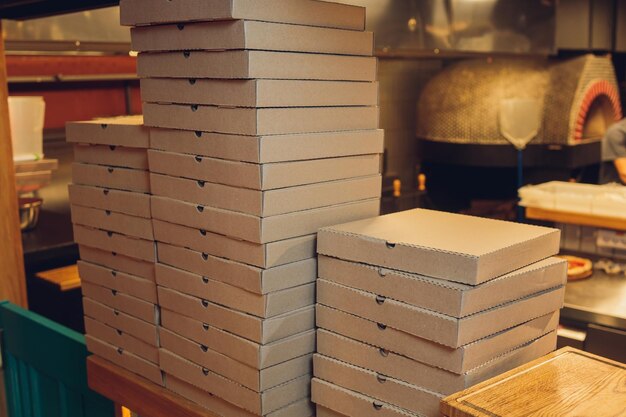 Pizzas cardboard boxes for shipping and delivery a lot of packaging is on the kitchen stock