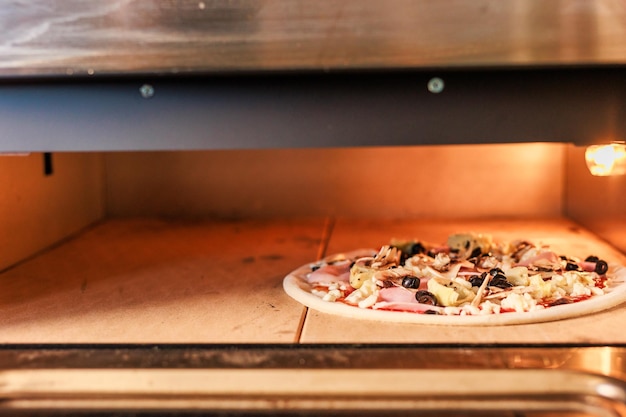 Pizzeria industrial professional metal oven food closeup in pizza restaurant no people background